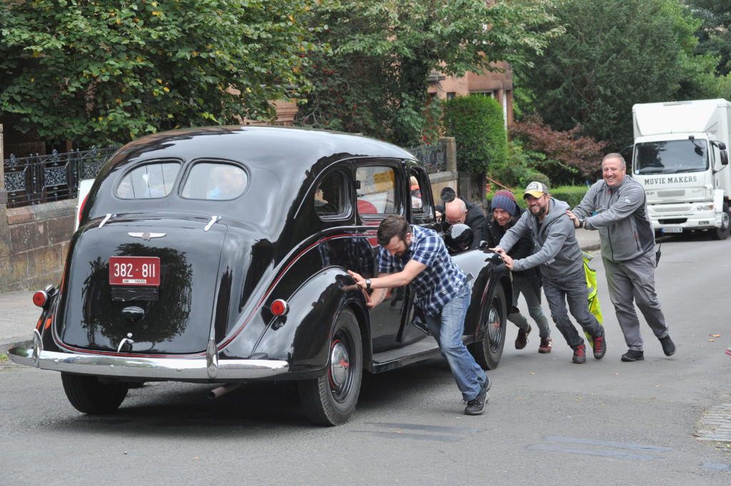 OUTLANDER FILMING IN DOWANHILL STREET GLASGOW CAR HAD TO BEPUSHED BACK UP HILLAS IT WOULDNT START